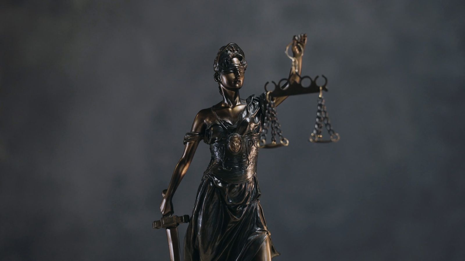 Close-up of a bronze Lady Justice holding the scales