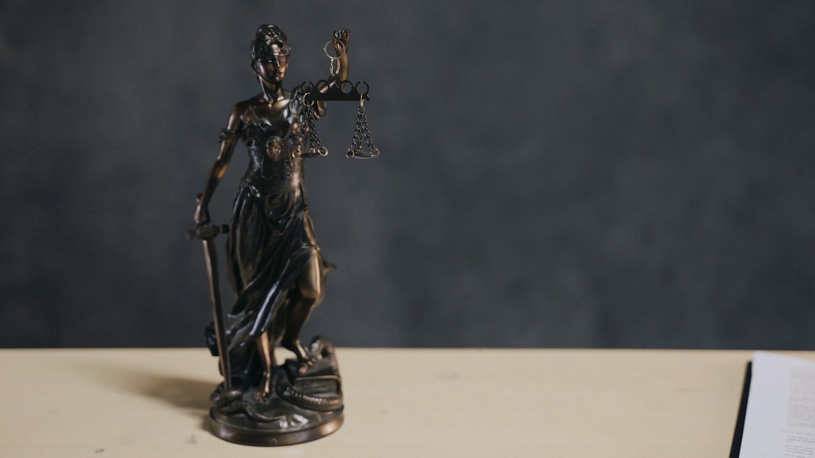 A bronze statue of Lady Justice holding the scales